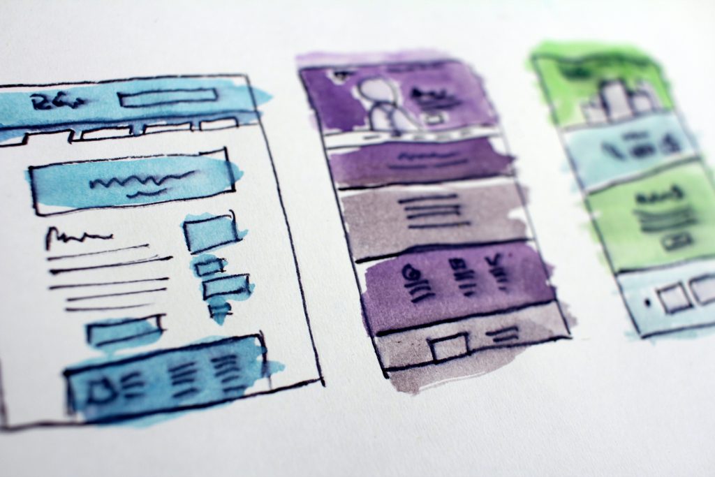 three drawings of a website design layout plan in blue, purple and green watercolour 