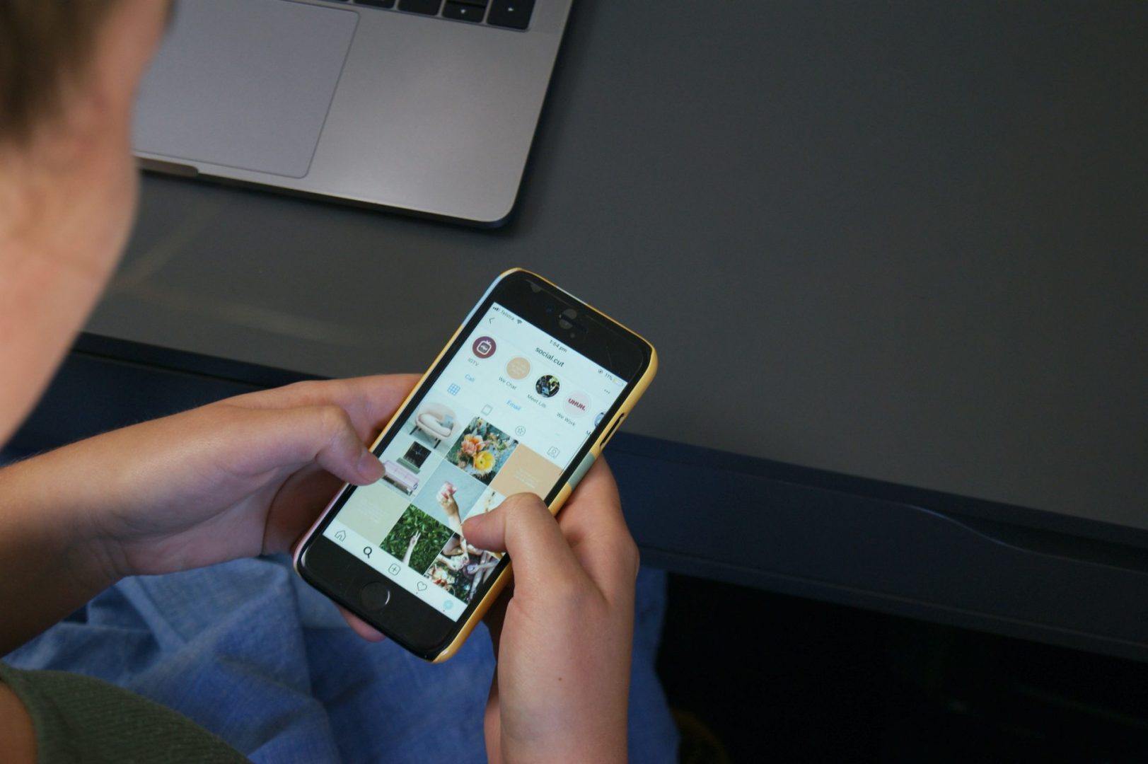 man on phone browsing through a business' instagram