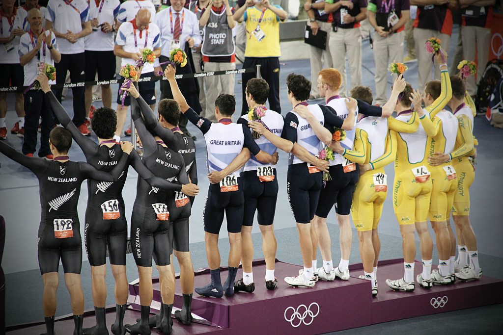 olympic winners showing off their medal 