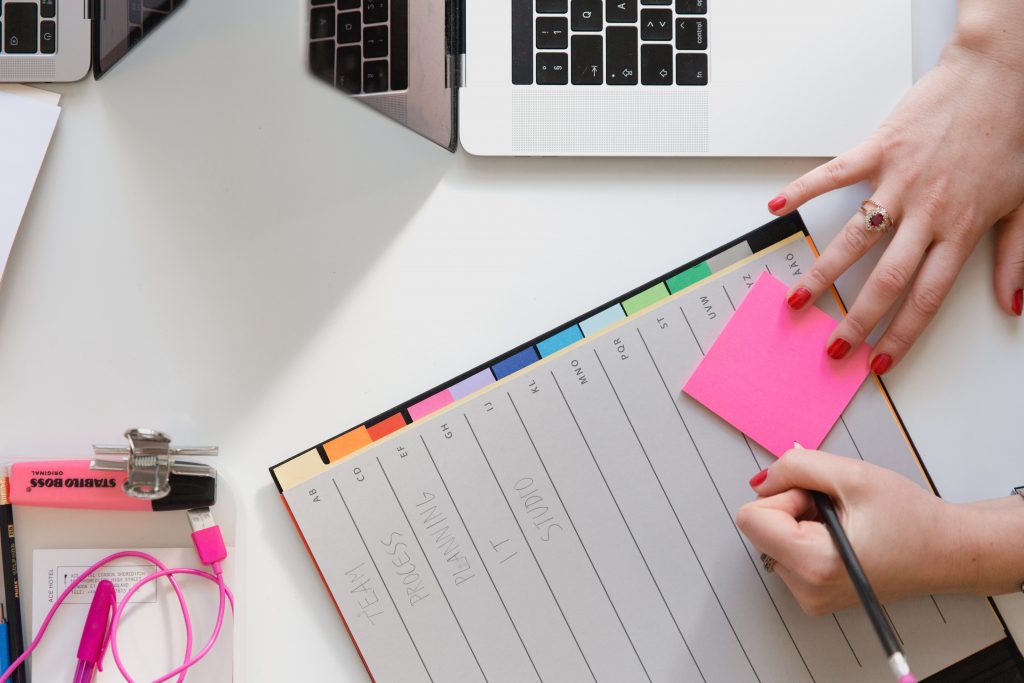 notebook and post-it notes for noting down social media scheduling plans