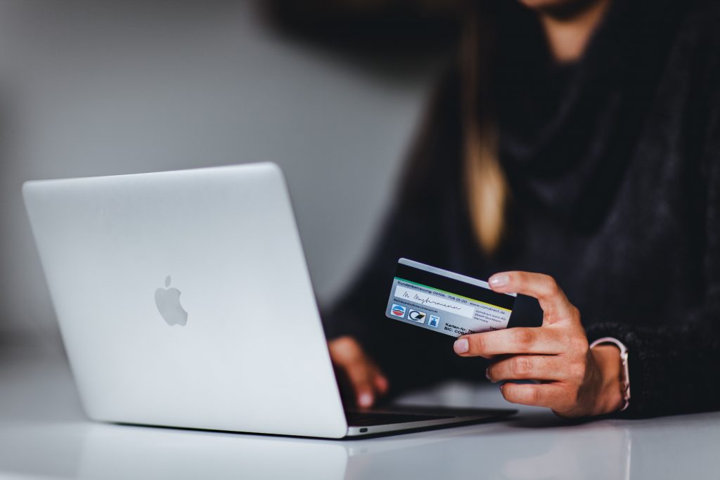 person at a laptop about to fill in their credit card details online.