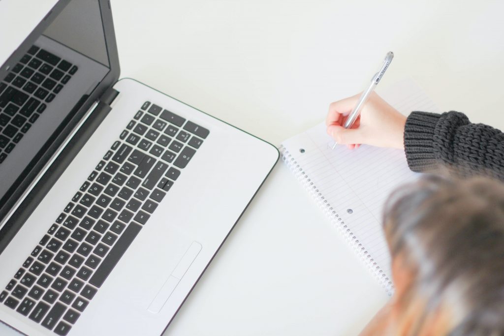 22 group employee writing down notes for updating website content