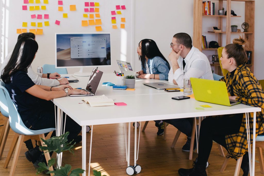 22group employees sitting round a table discussing a new strategy